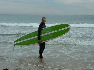 Kurt with our surfboard, The Wolf © Stephanie Glaser