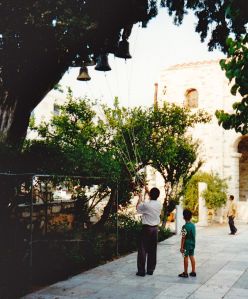 Finding my moment in Paros, Greece as I watch a man and his son ring bells after the Christening of a new baby at a Greek Orthodox Church.  