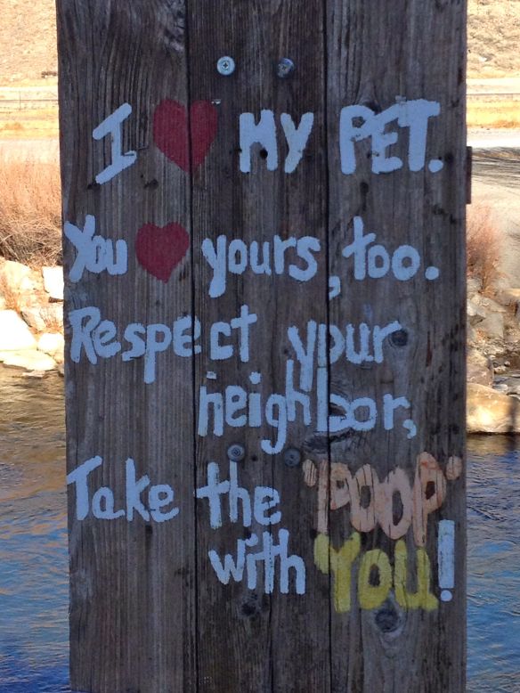 A friendly clean up your dog's poop sign