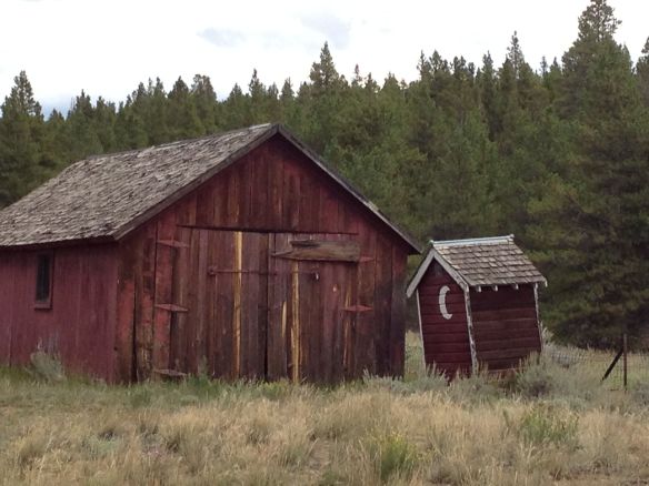 Another building along with an outhouse on the church property.