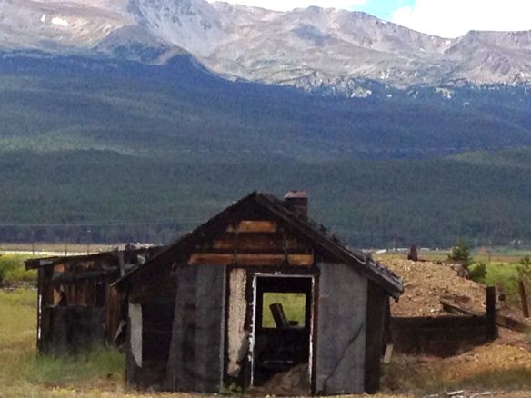 You can still enjoy fantastic views while reclining in a  favorite chair that remains in this wooden cabin. 
