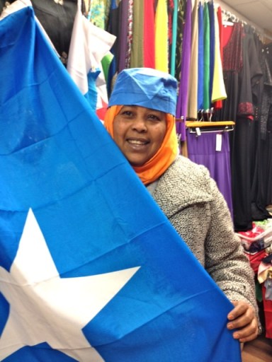 Maryan happily poses for me with the Somali flag and a Somali hat 