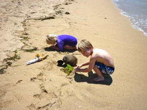 Kasey and Eddie with treasures on the beach in Sanur.