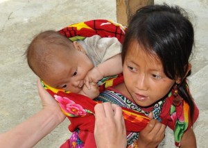 Deb adjusting the little girl's wrap