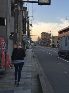 Suz walking on a deserted street